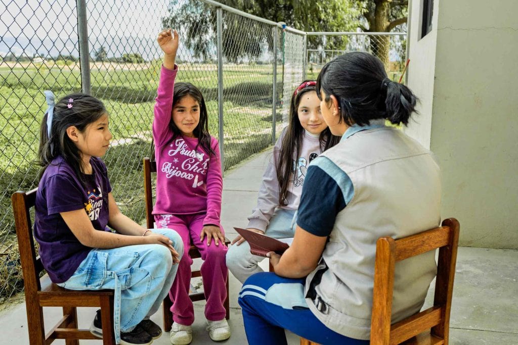 Mädels sitzen im Stuhlkreis und melden sich, Wie wir Kinder schützen wollen, Compassion Deutschland